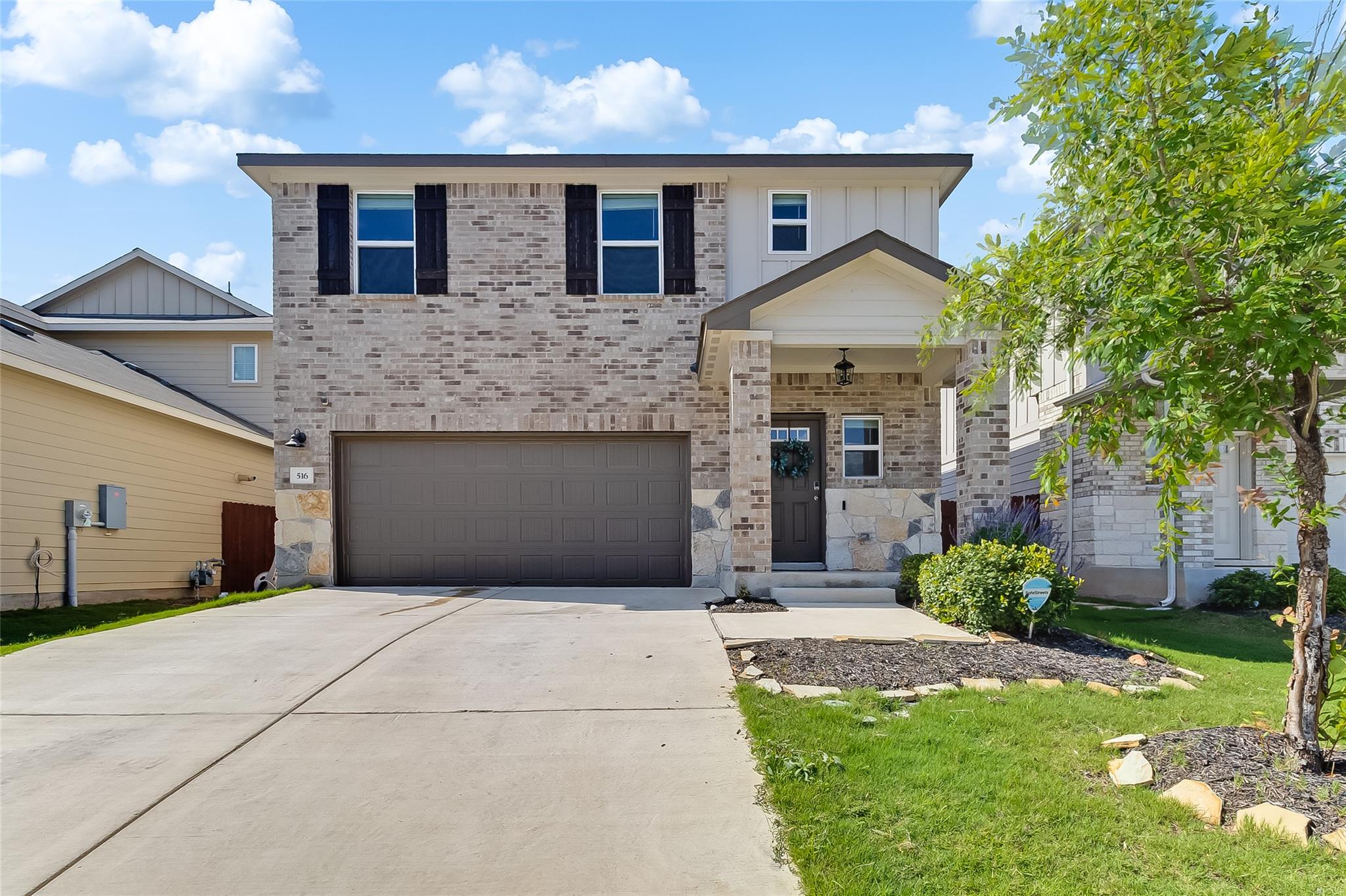 View of front of house with brick siding, concret