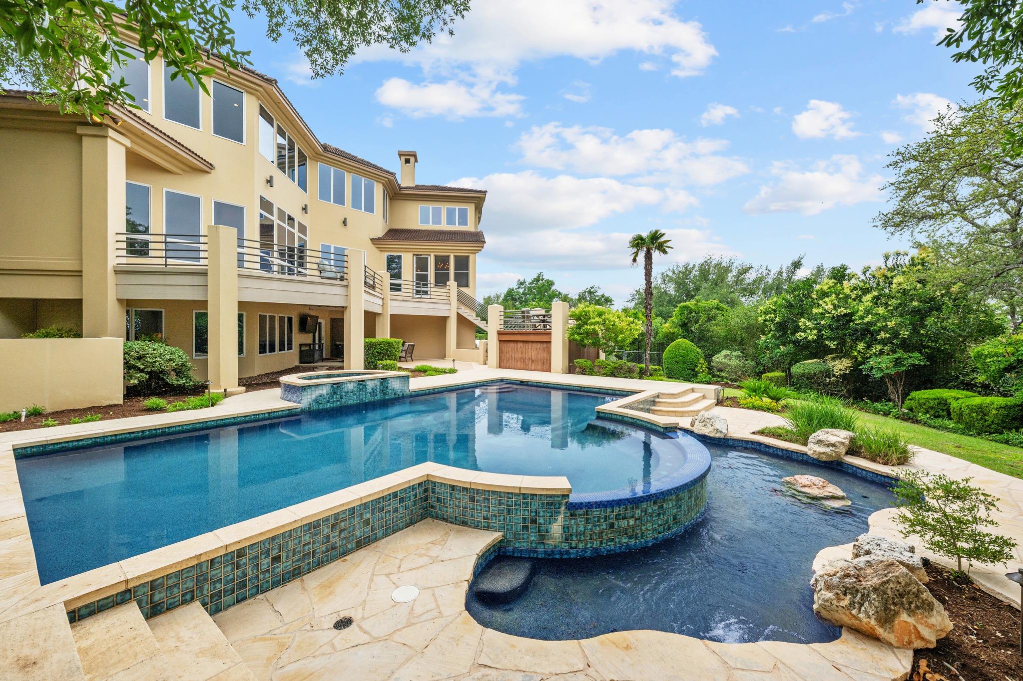 Multi-level exterior featuring a large swimming p