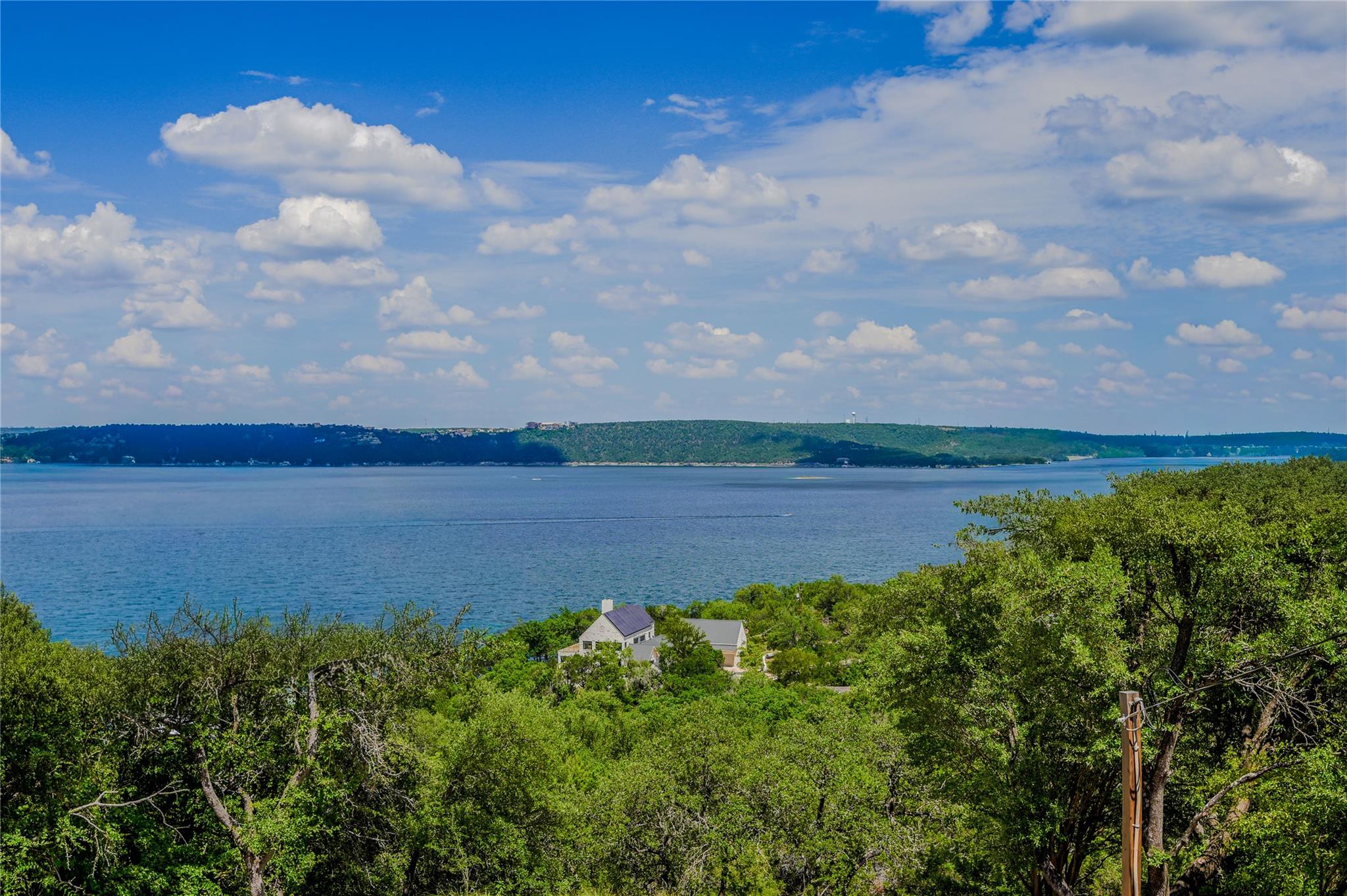 Gaze across lush treetops to sweeping views of th