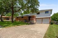 Split level home featuring concrete driveway, a g