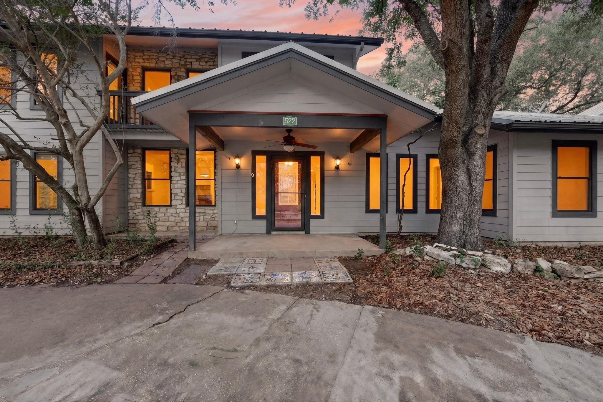 A welcoming stone and siding facade with an invit
