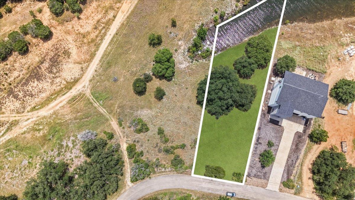 A verdant lakeside lot featuring a contemporary h