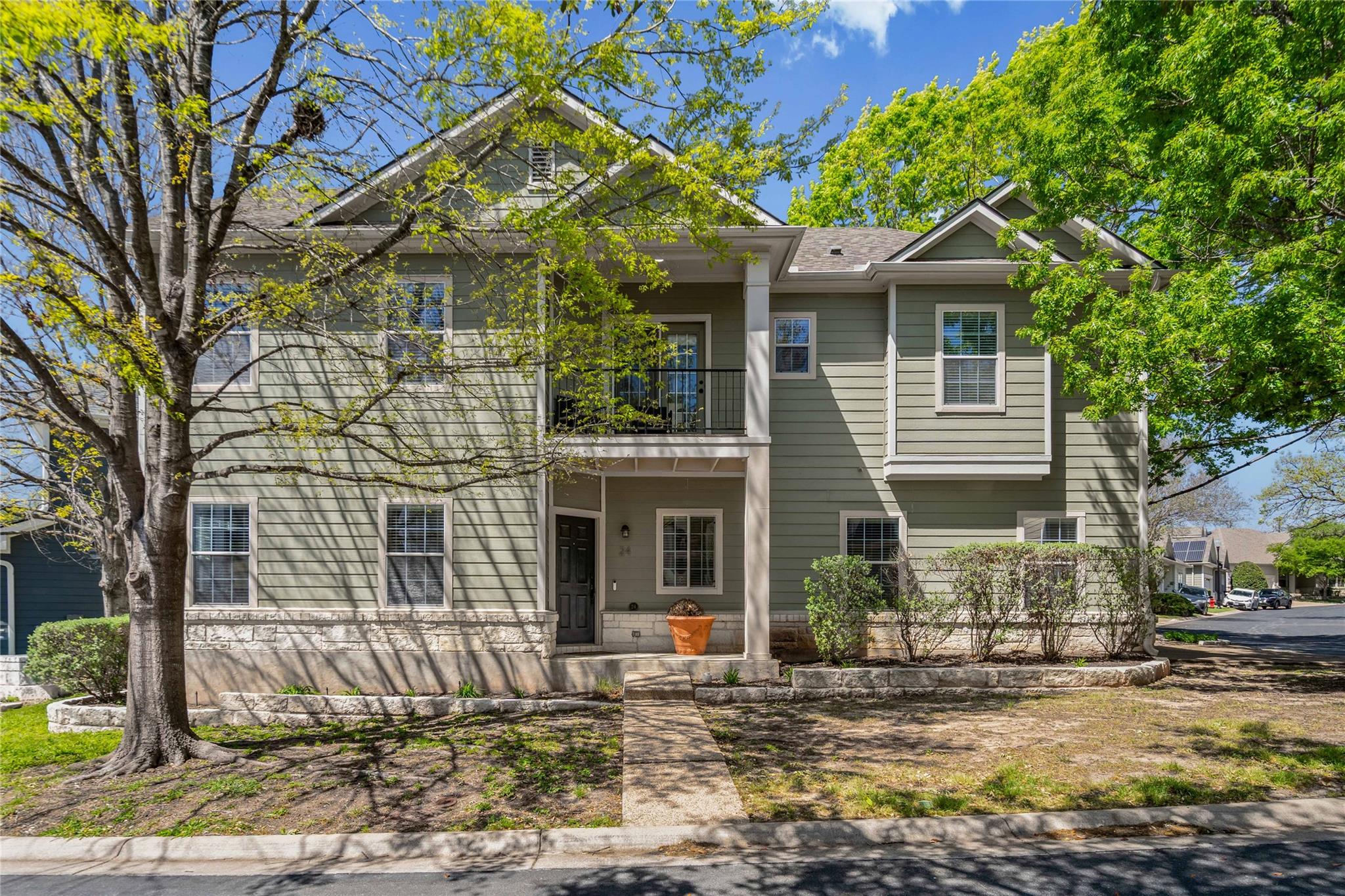 View of front of property with a balcony and cove