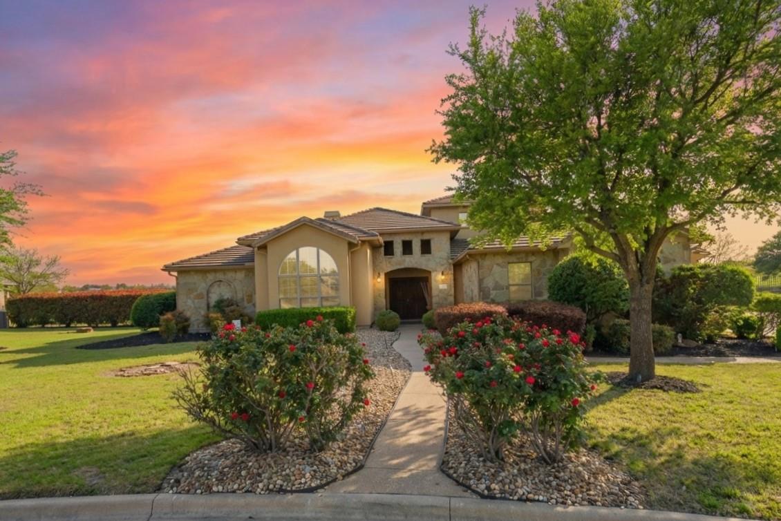 Mediterranean / spanish home with a lawn, stone s