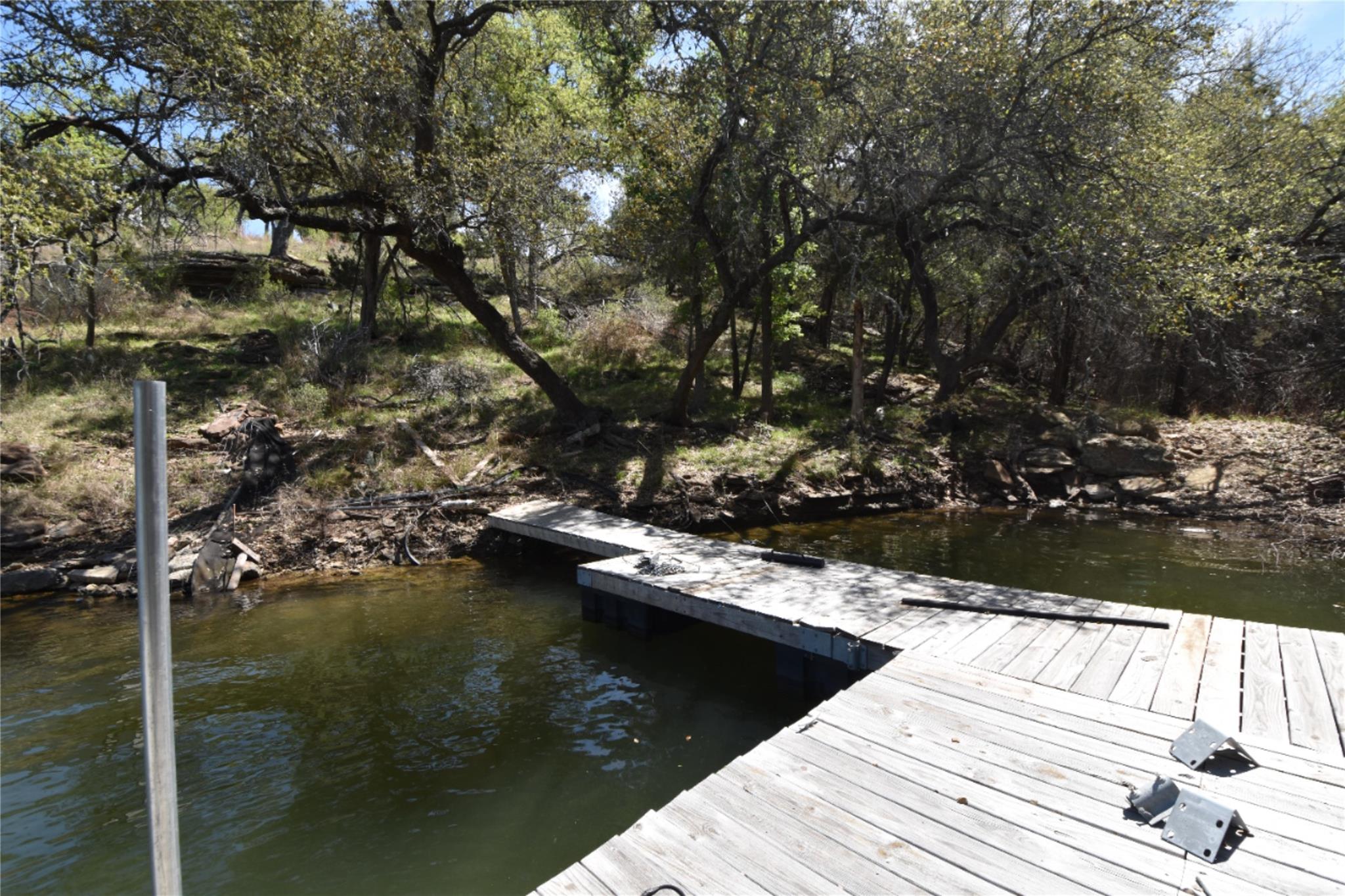 Dock area featuring view of wooded area