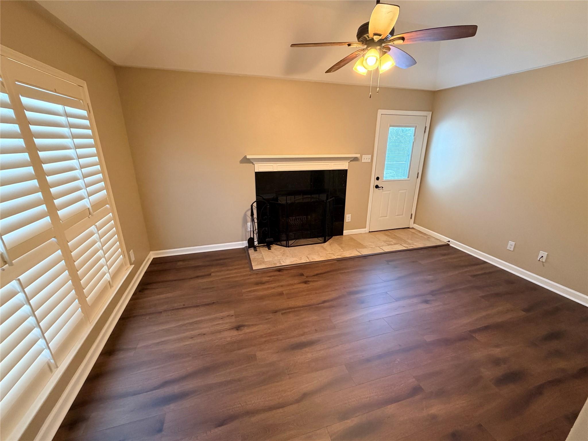 Unfurnished living room with a fireplace with flu