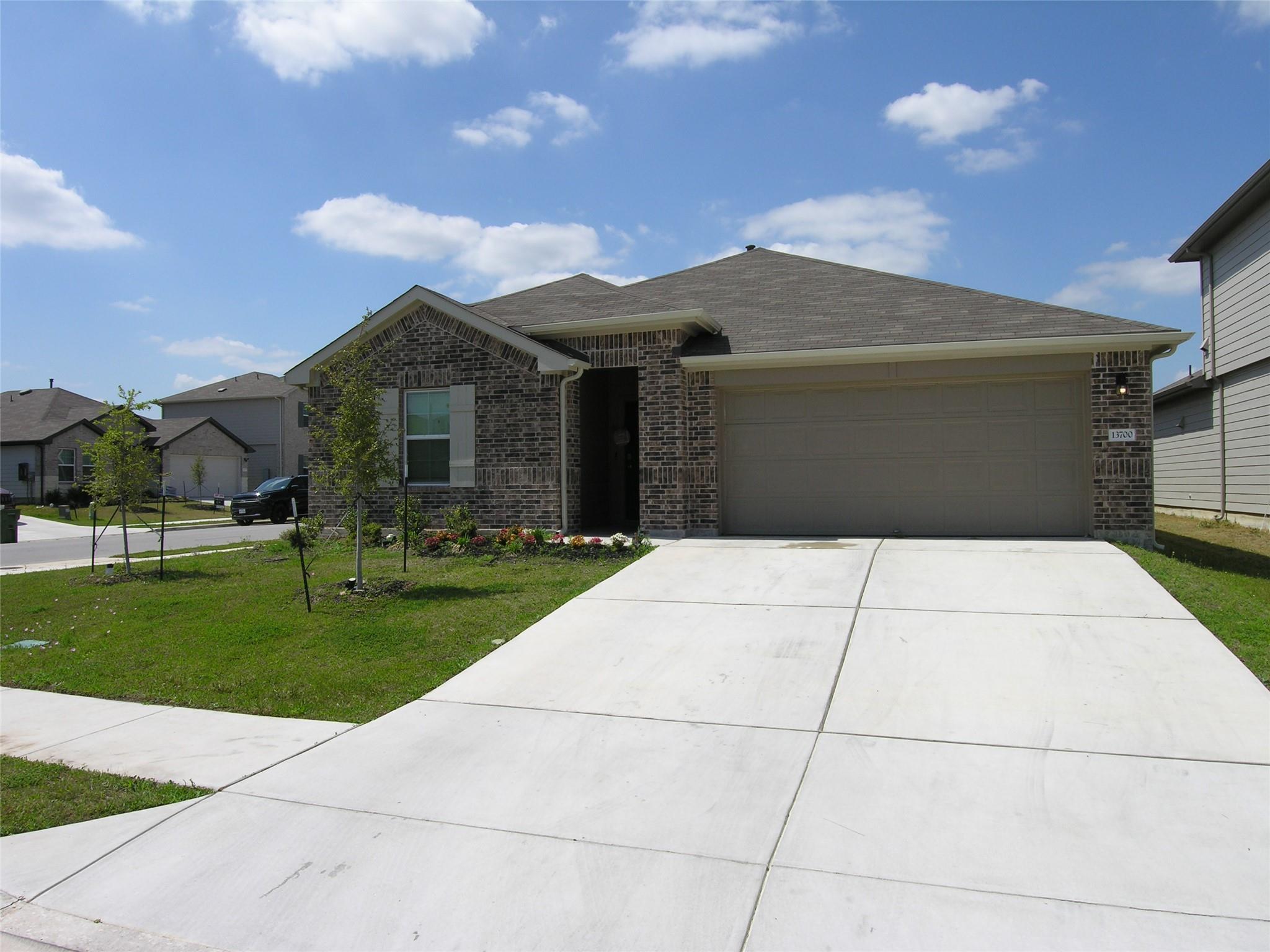 Ranch-style home featuring brick siding, concrete