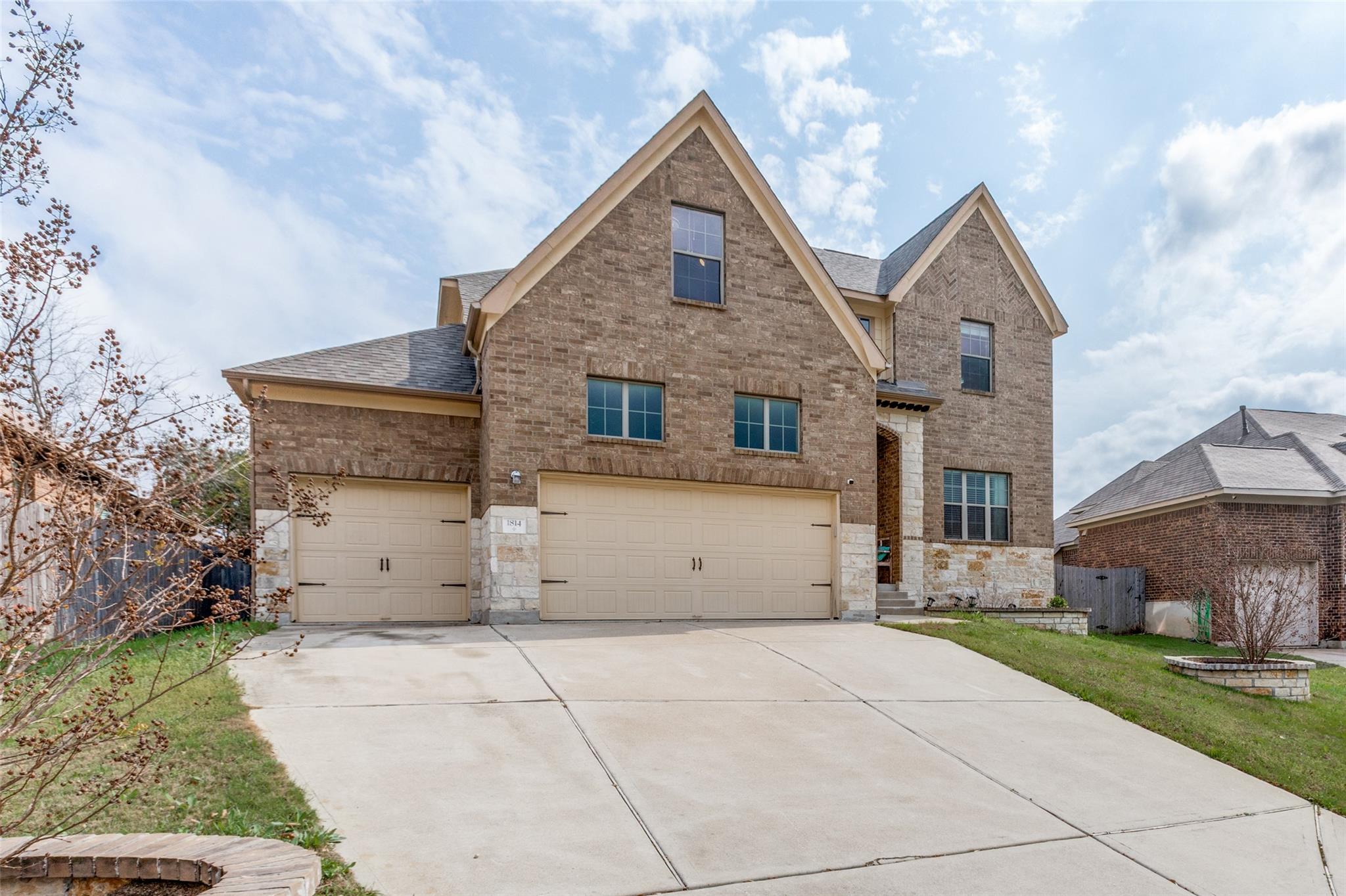 Traditional-style house featuring brick siding, d