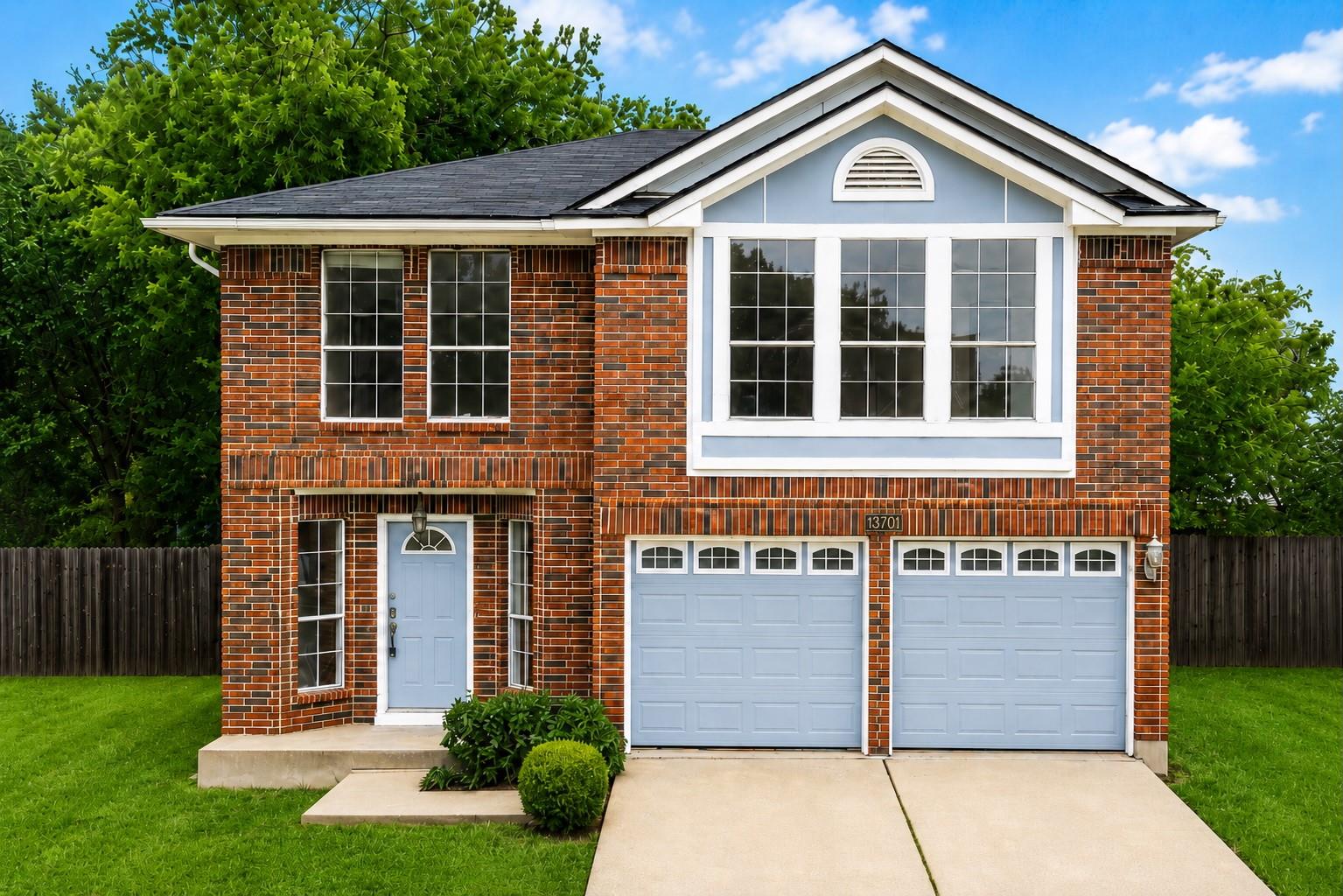 Brick facade home featuring a light blue front do