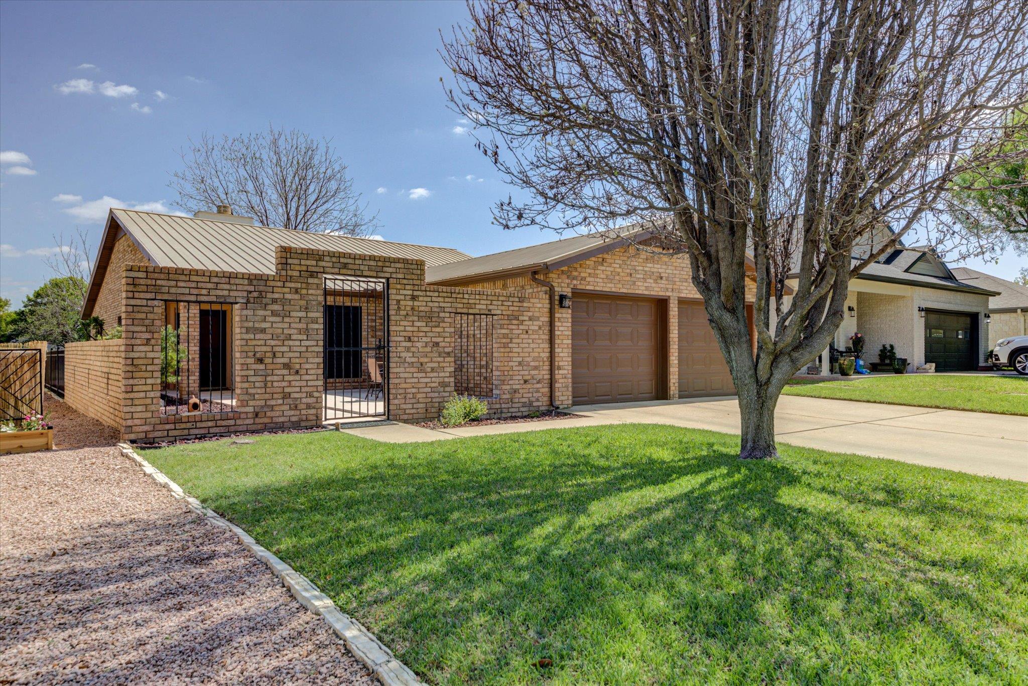 View of front of house featuring brick siding, an