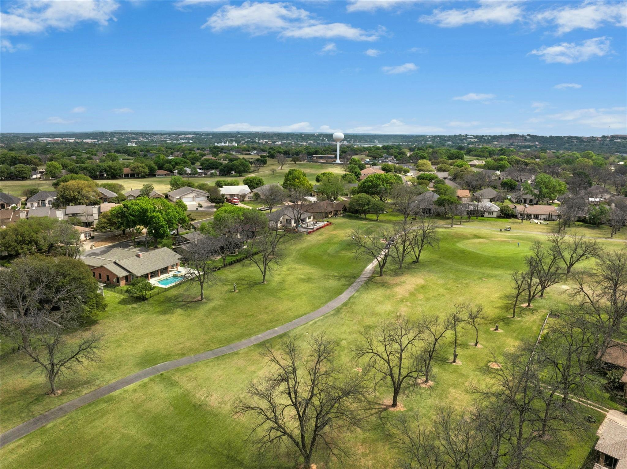 Aerial perspective of suburban area with a golf c