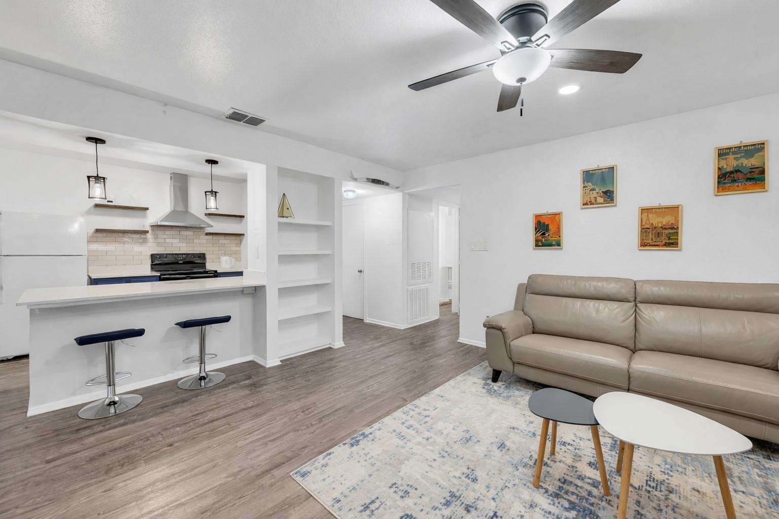 Living area featuring wood finished floors, a cei