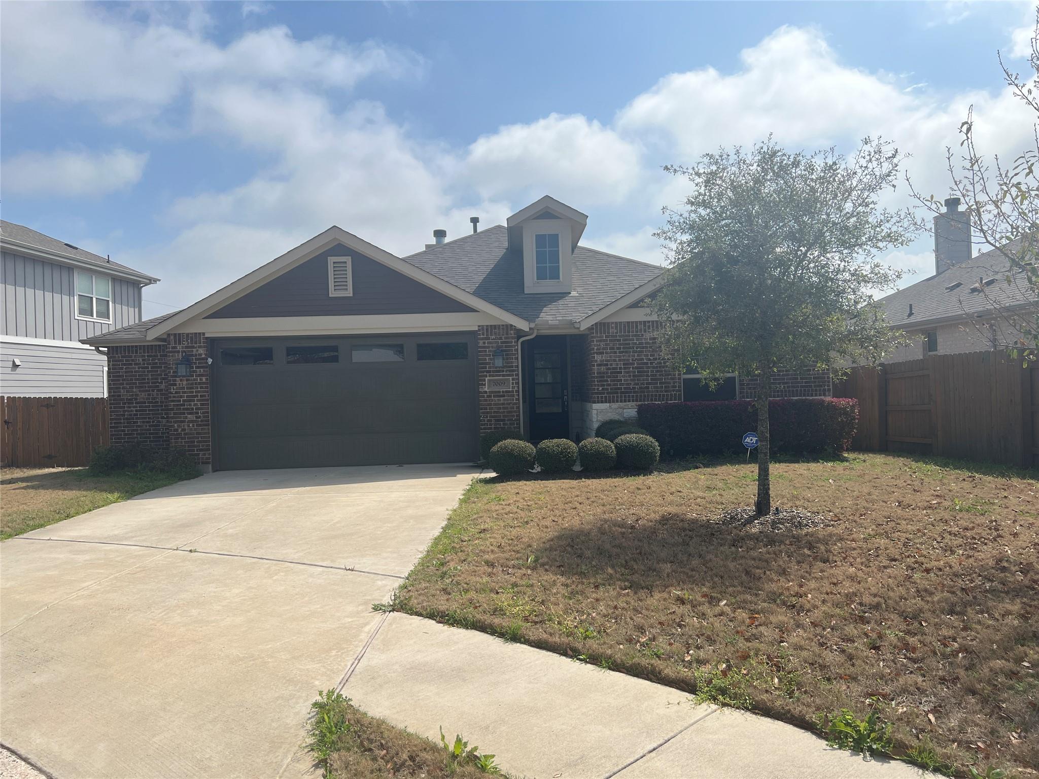 View of front of home featuring brick siding, dri