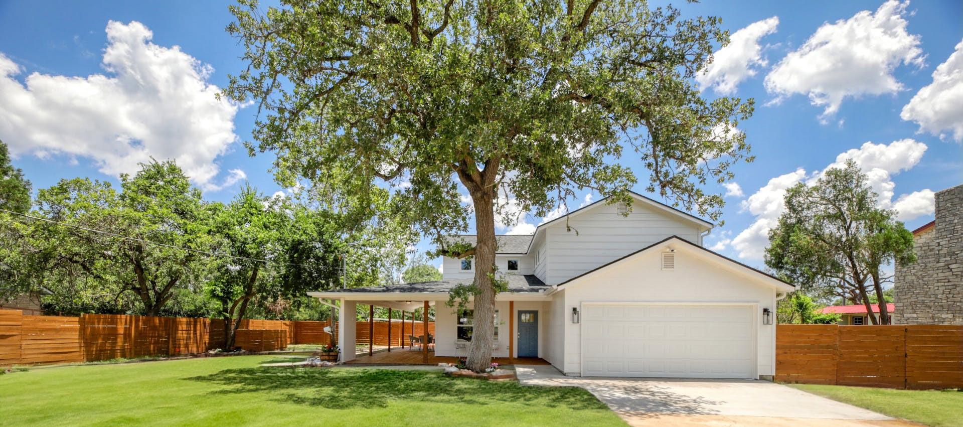 View of front of home featuring a garage and conc