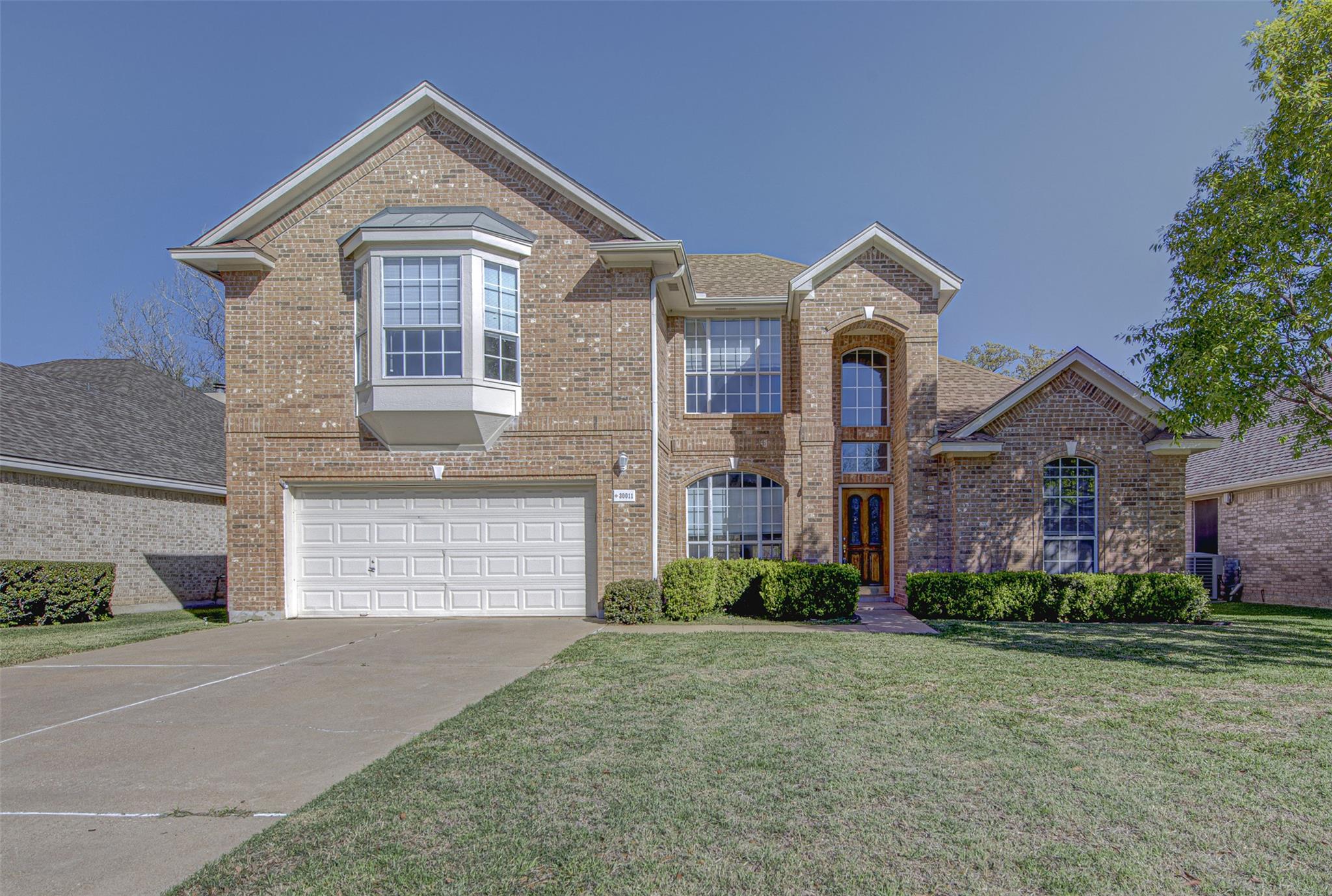 Traditional-style house featuring brick siding, a