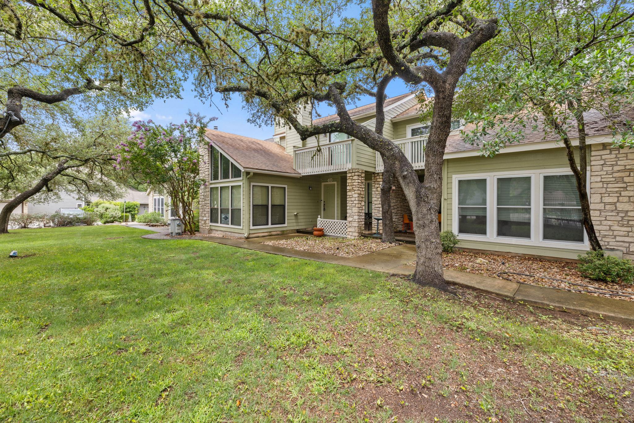 Mature trees shade this inviting residence, featu
