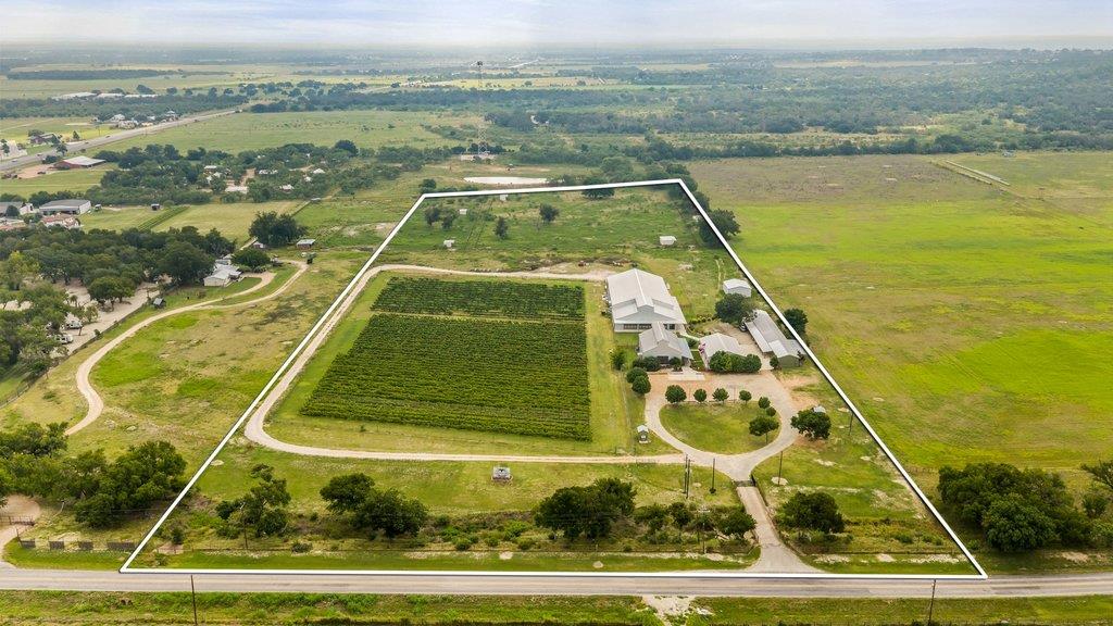 An aerial perspective reveals a vast estate, comp