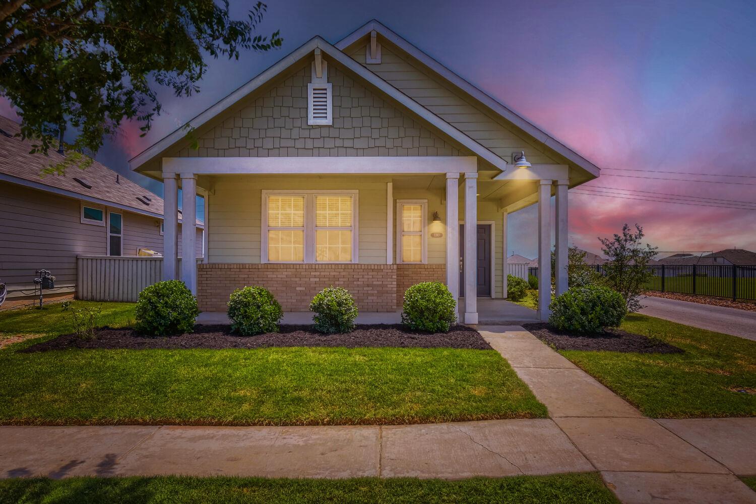 Front exterior featuring a covered porch with whi