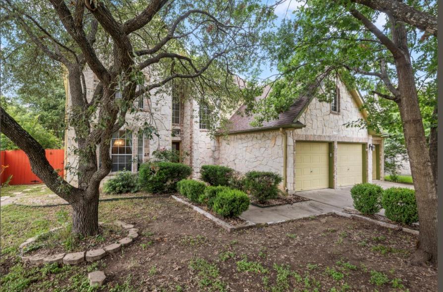 Mature trees and tidy landscaping frame this invi