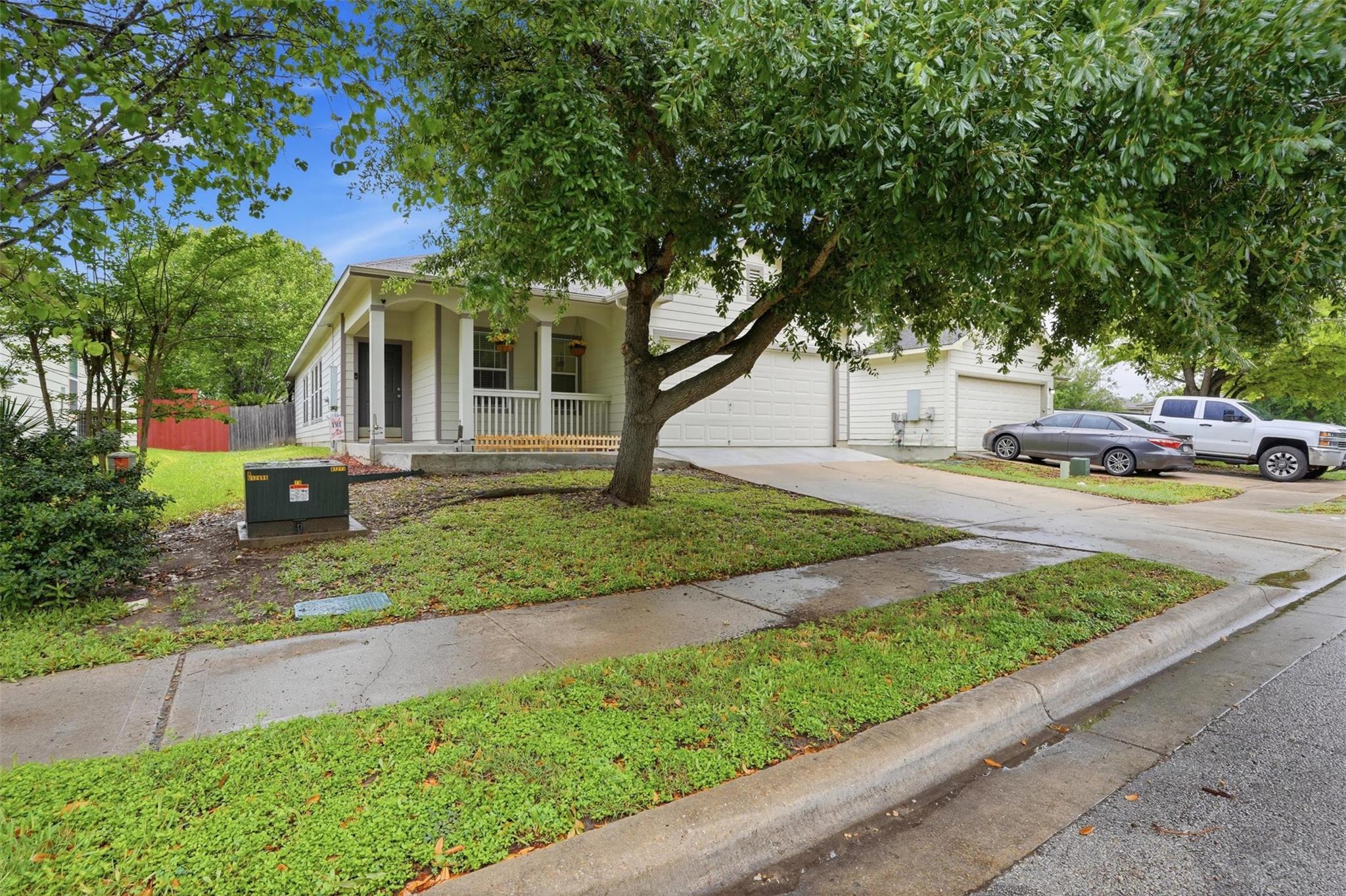 The property features a white exterior, a covered