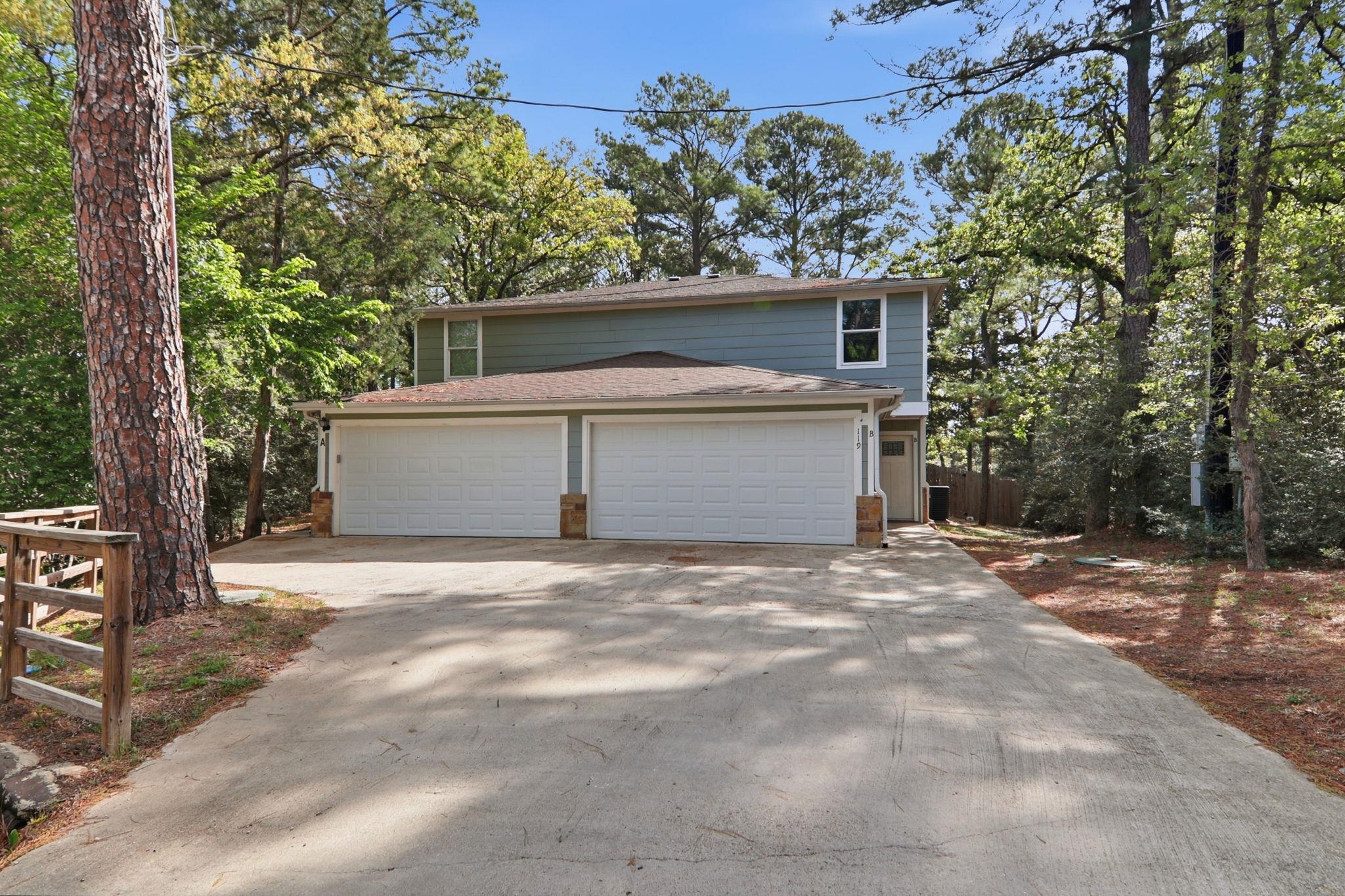View of front of home with a garage, a shingled r