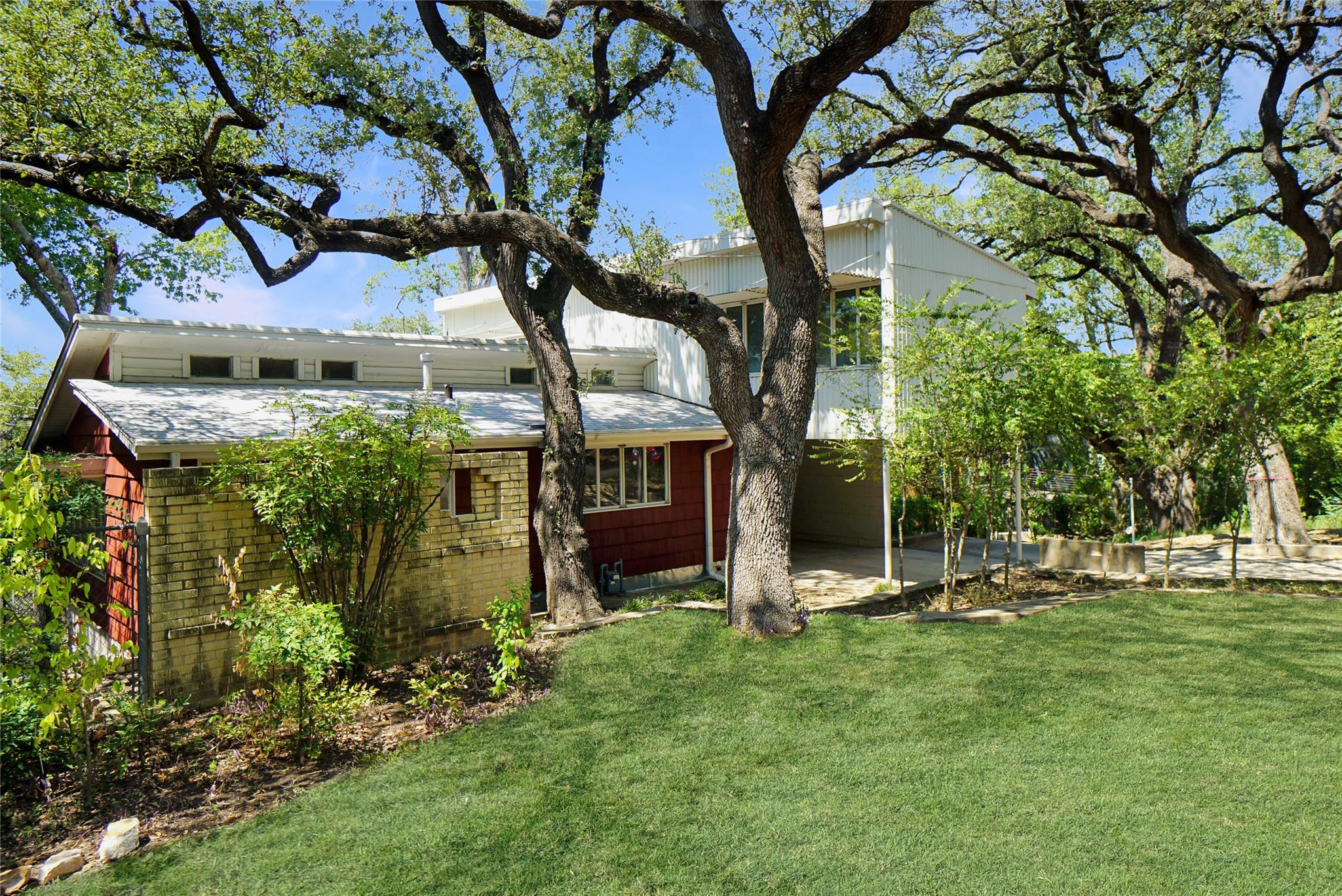 Rear view of house with a lawn