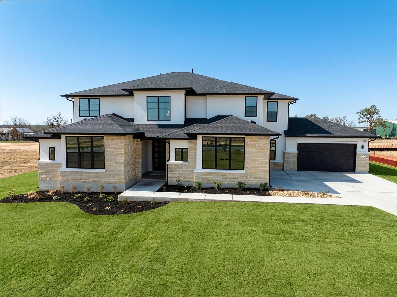 Prairie-style home with concrete driveway, a fron