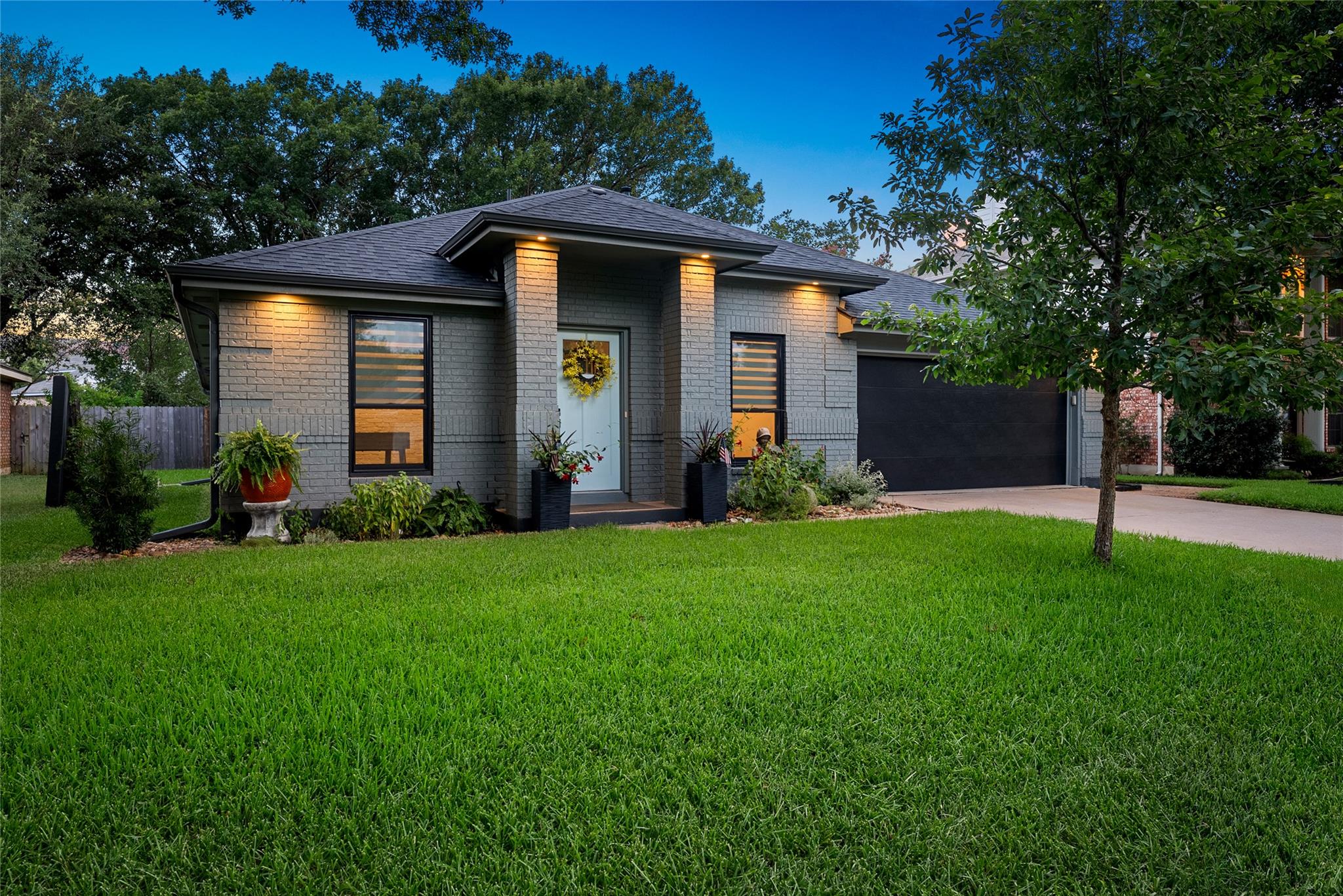 A neatly maintained front yard complements this c