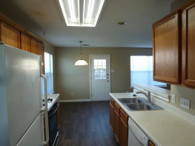 Kitchen featuring wood finish cabinetry, white ap