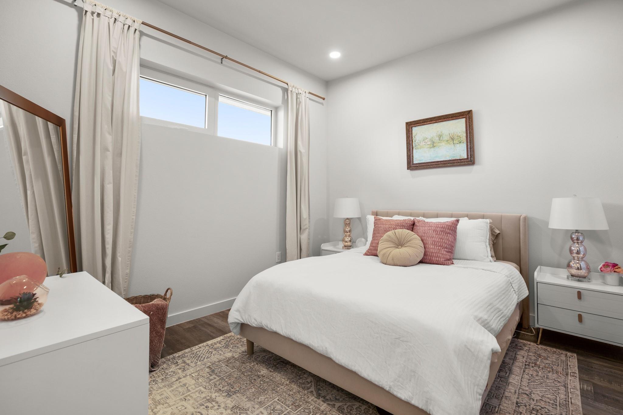 Bedroom with wood finished floors and recessed li