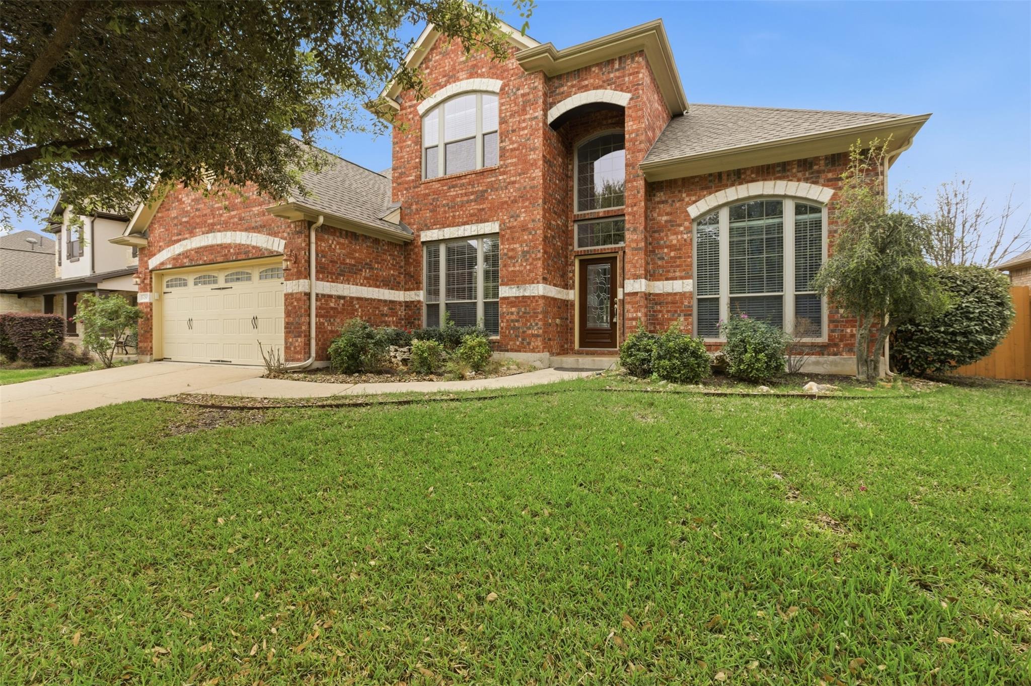 Traditional home featuring brick siding, a front 