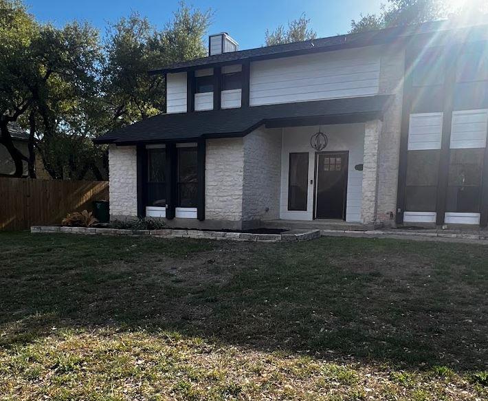 View of front of house featuring stone siding and
