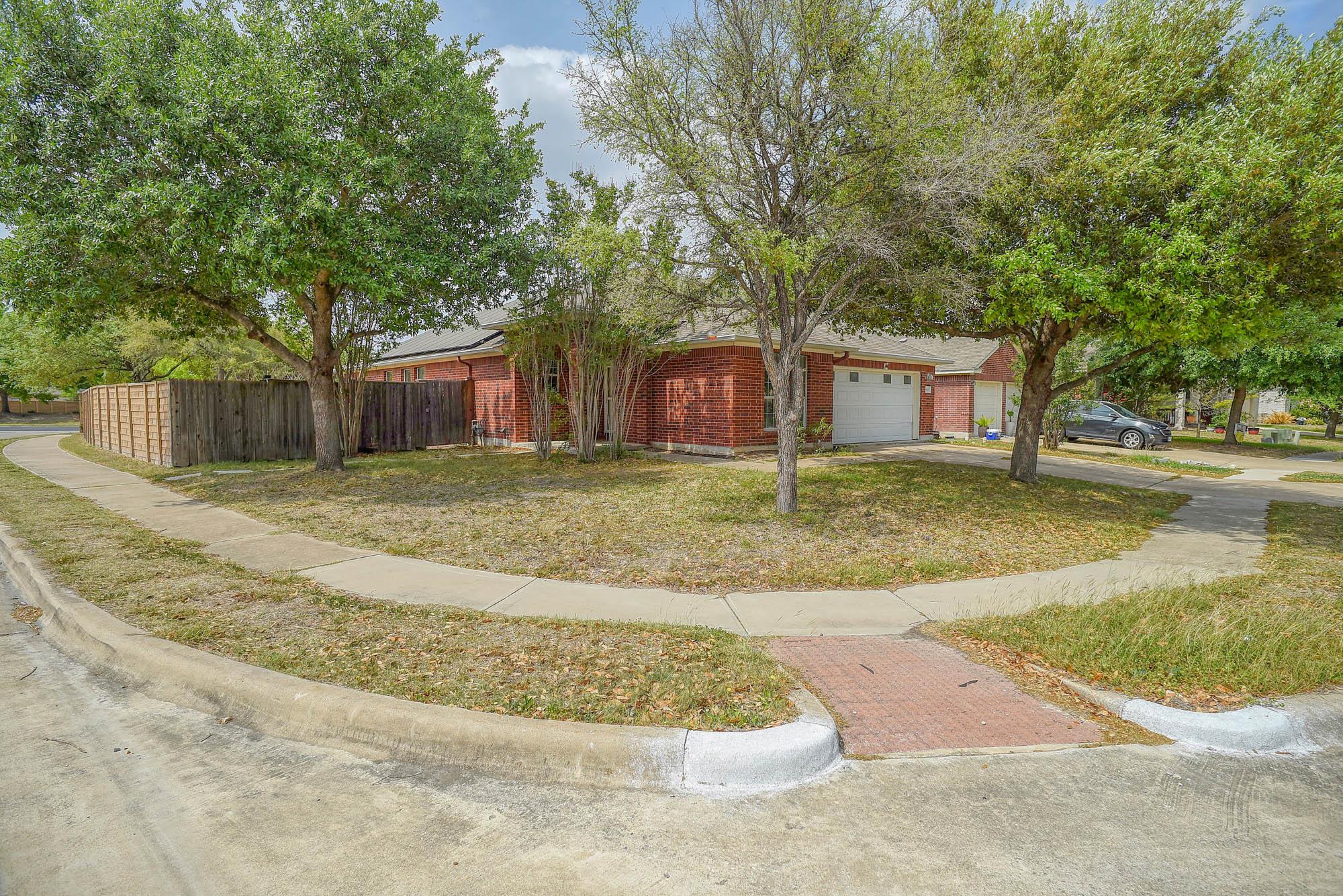 View of front facade featuring concrete driveway,