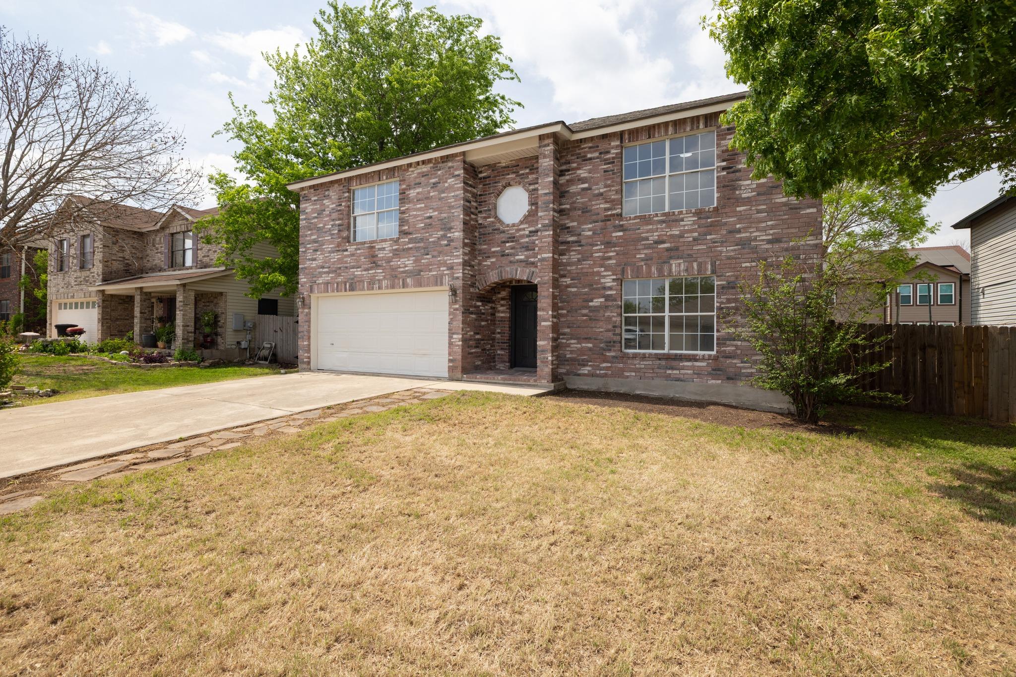 Traditional-style house featuring concrete drivew