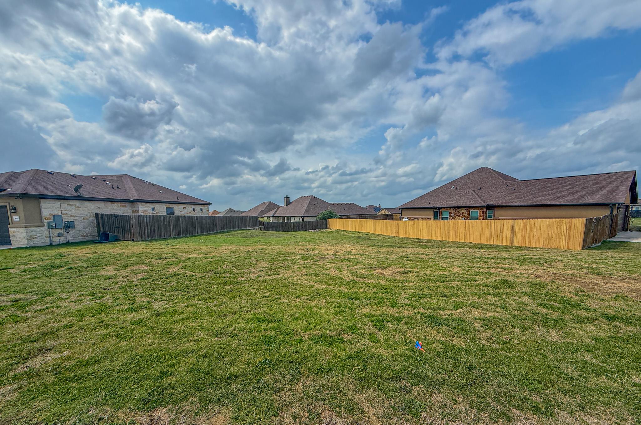 Fenced yard with a residential view