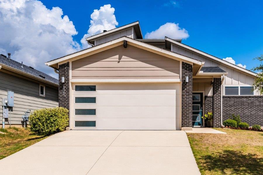 Modern facade featuring a segmented garage door w