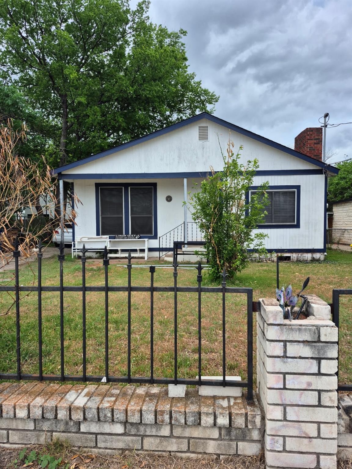Bungalow-style house featuring a fenced front yar