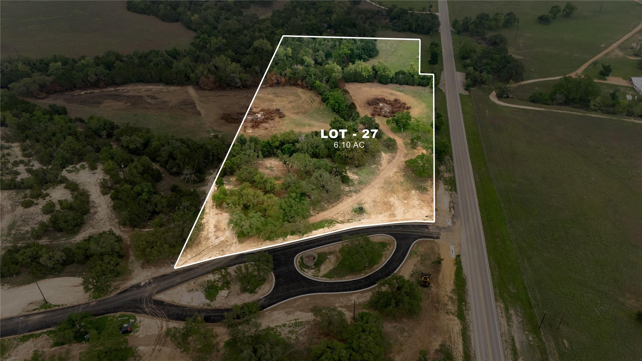 6.10-acre lot featuring a mix of mature trees and