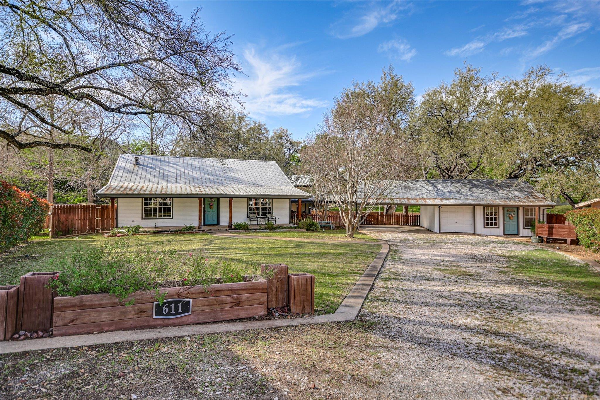 Single story home featuring driveway, a carport, 
