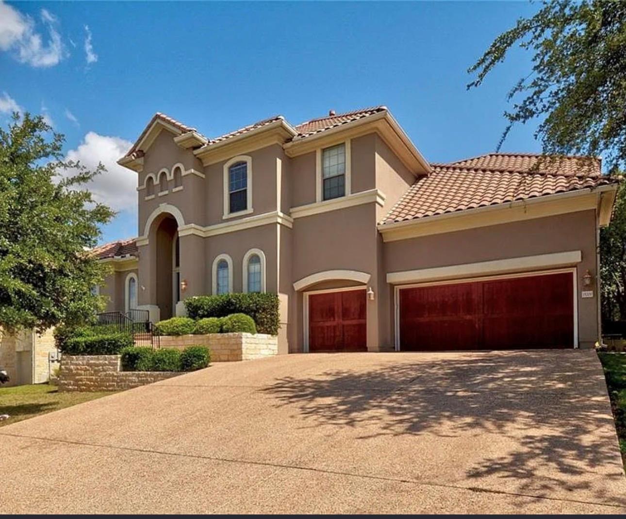 An elegant stucco facade with a classic tile roof