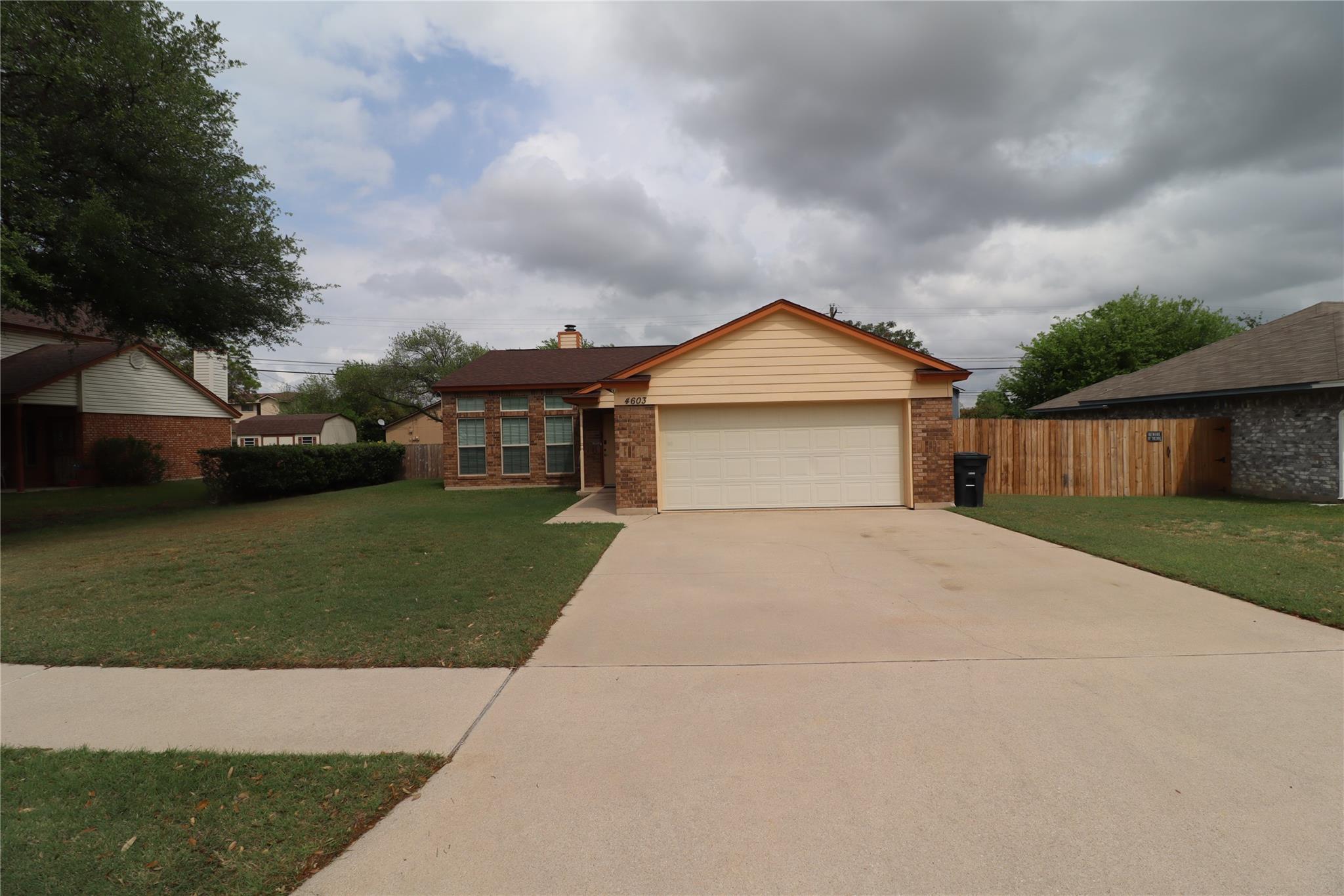 Single story home featuring brick siding, an atta