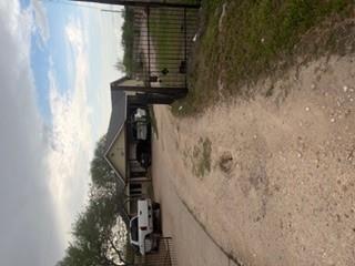View of front of home with dirt driveway