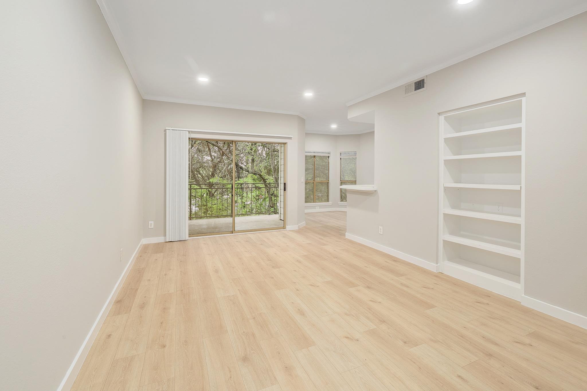 Bright living area featuring wood-finish flooring