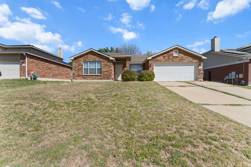 Single story home with a garage, a front yard, br