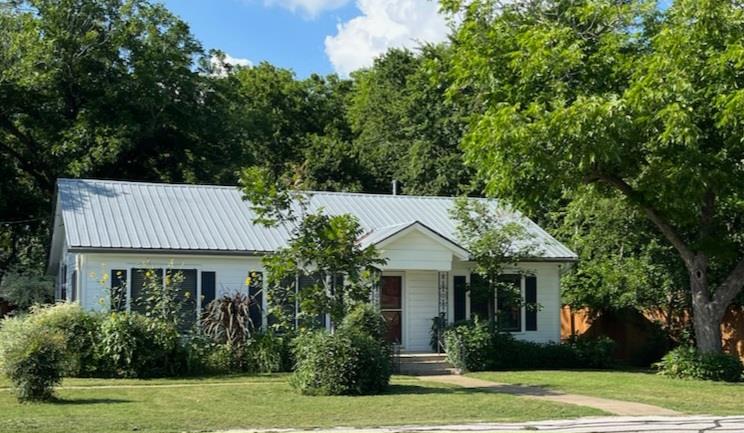 This charming property features a white exterior 