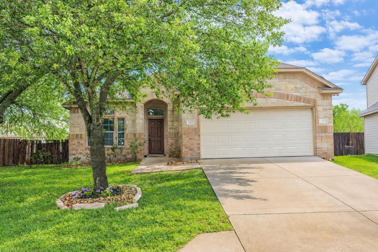 View of front of property with concrete driveway,