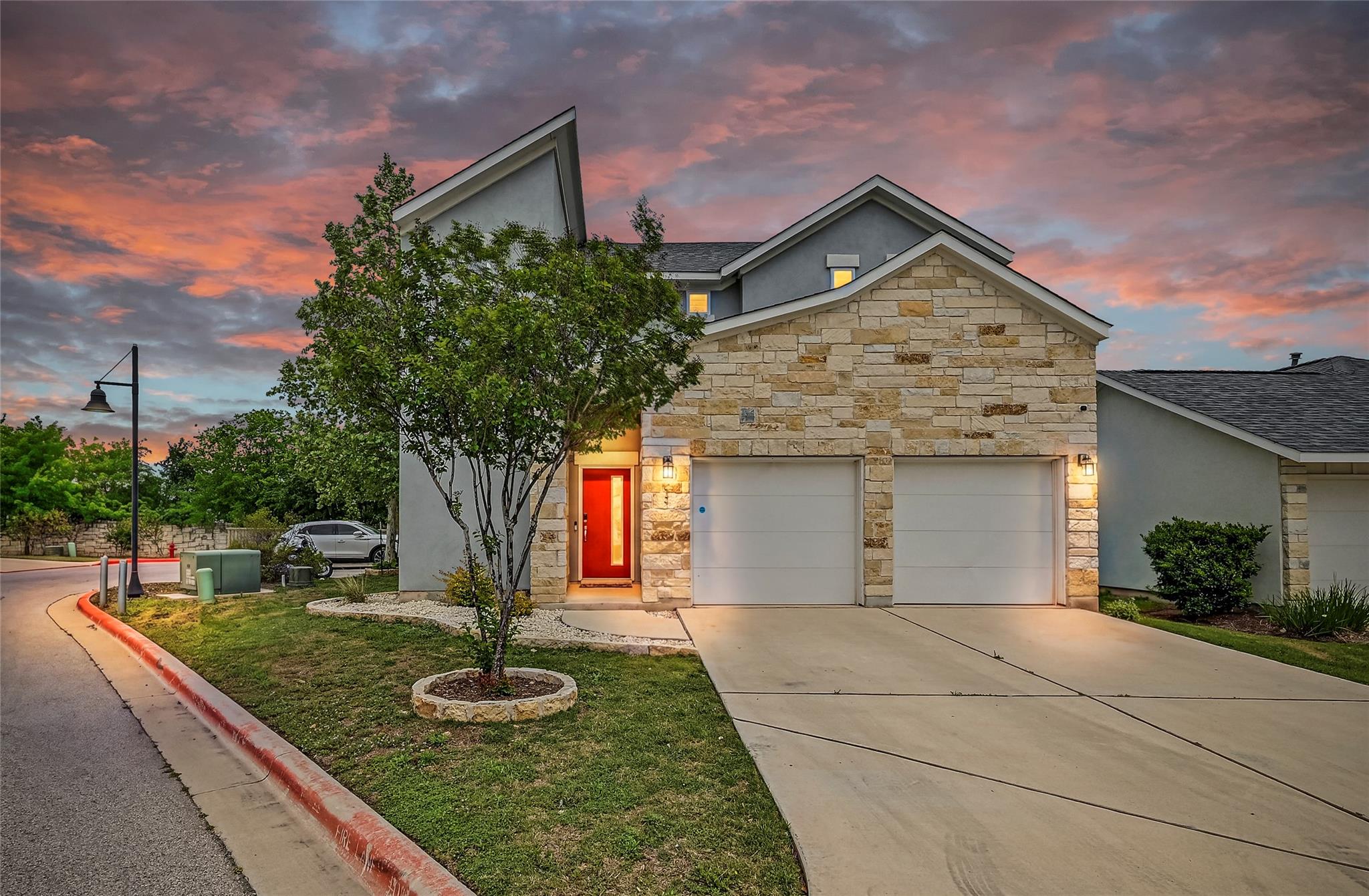 View of front of property featuring stone siding,