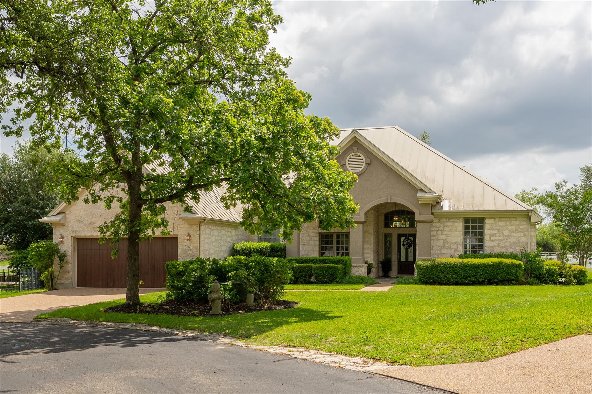 The property features a stone exterior, a metal r