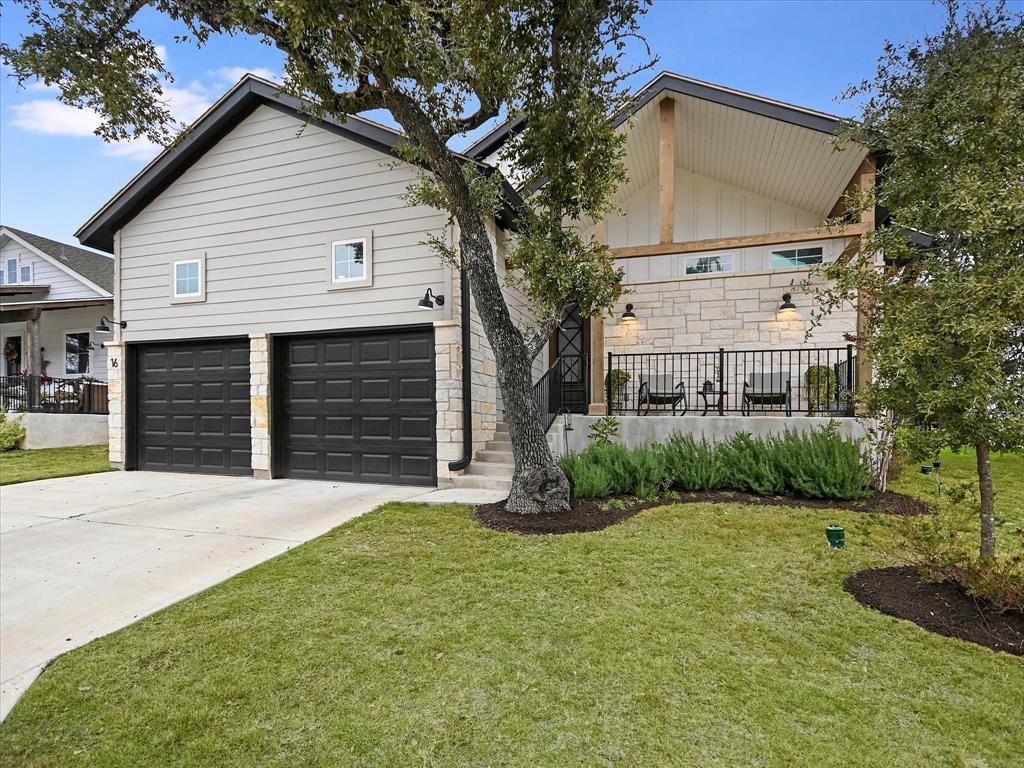 View of front of home with driveway, a front lawn
