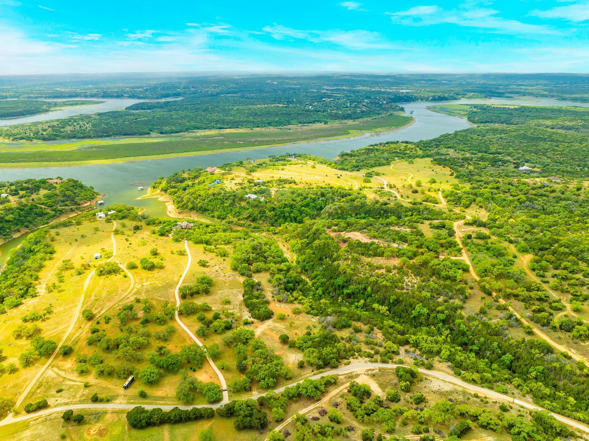 Aerial view of a nearby body of water and a forest